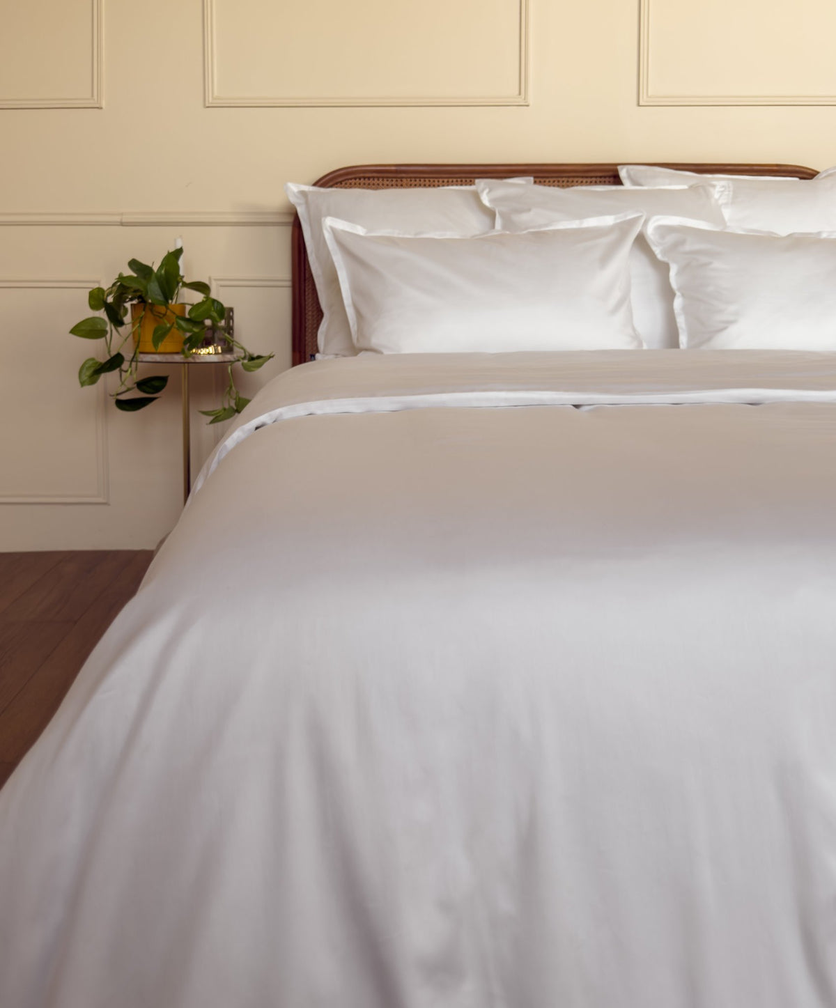 Élastique tête et pied d'un drap-housse en satin de coton bio blanc, bien tendu sur le matelas